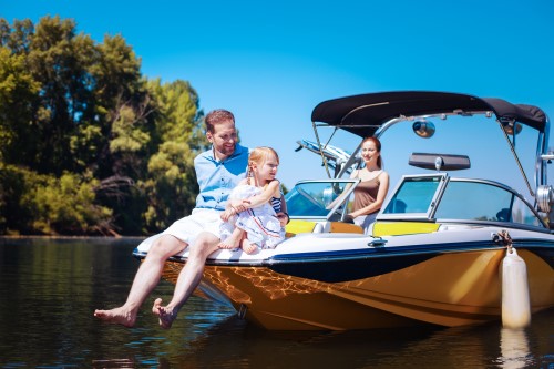 Happy family sitting on a boat